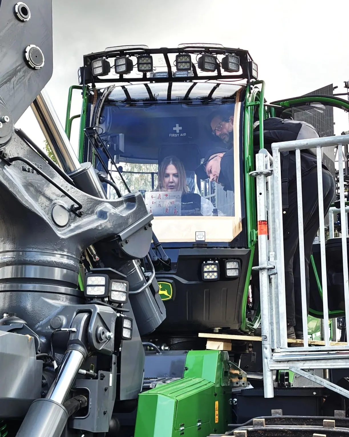 woman andman looking inside a tractor