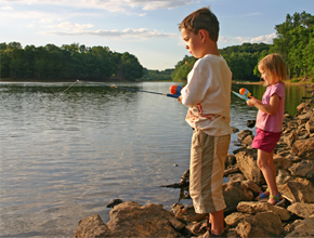 Two kids fishing on a lake